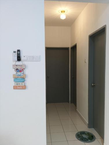a hallway with two doors and a tile floor at mazya homestay in Melaka