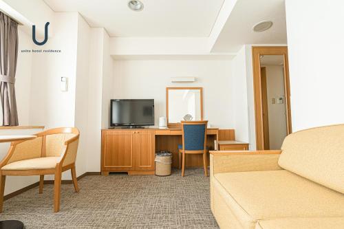 a hotel room with a bed and a tv at Forest Hongo by unito in Tokyo
