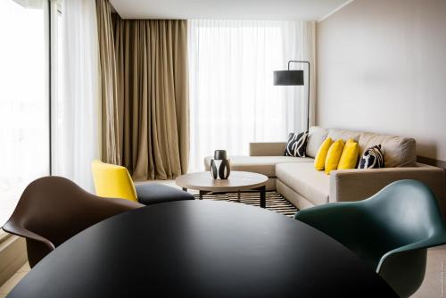 a living room with a couch and a table at Simon Hotel in Fort-de-France