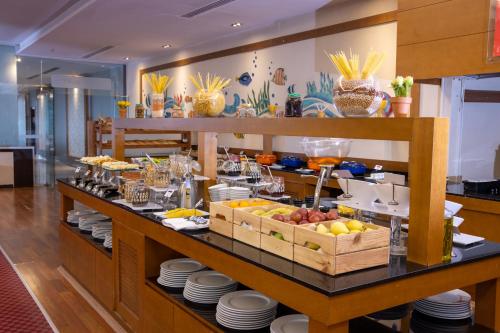 a buffet line with plates and fruit on display at Anemon Grand Eskişehir Otel in Eskisehir