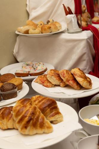 a bunch of pastries on plates on a table at Maxland Hotel in Nairobi