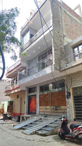 a moped parked in front of a building at Shri Dev Dham in Vrindāvan