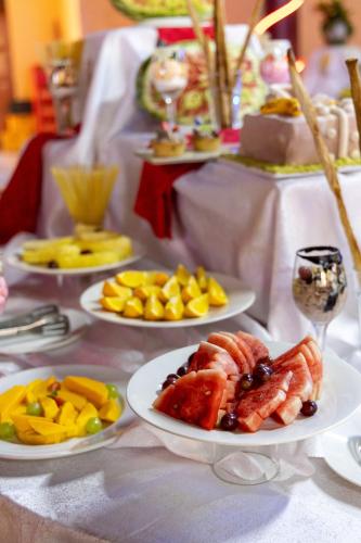 a white table with plates of food on it at Maxland Hotel in Nairobi