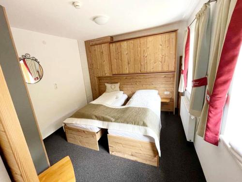 a small bedroom with two beds and a window at Apartment in Navis near Berger Alm Ski Resort in Navis