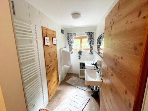 a bathroom with wooden walls and a sink at Apartment in Navis near Berger Alm Ski Resort in Navis