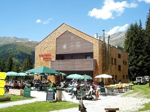 a group of people sitting outside of a building at Apartment in Navis near Berger Alm Ski Resort in Navis