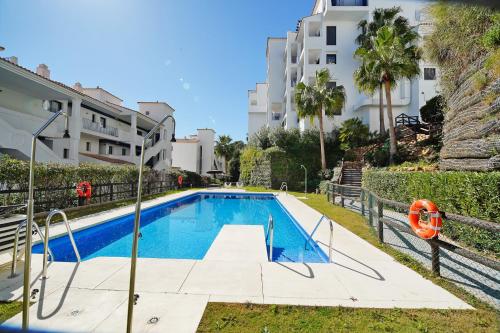 a swimming pool in front of a building at Sea view apartments with Year-Round Open Pool in Manilva