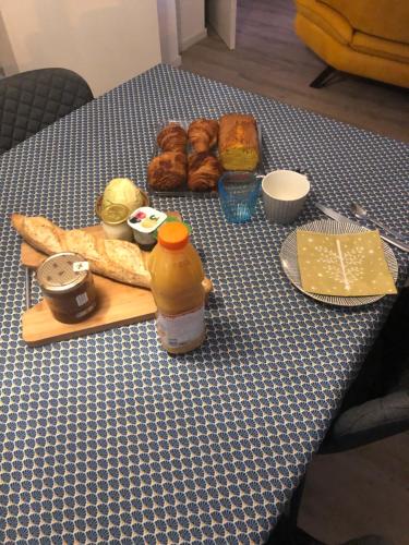 a table with bread and other foods on it at Chambre d hôtes chez Carol et Patrick in Gundershoffen