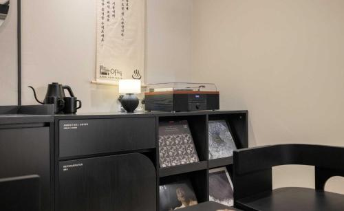 a desk with a computer and a radio on it at Aank Hotel and Spa Jongno Unni in Seoul