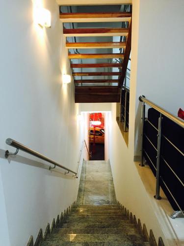 a stairway with a wooden railing and a stair case at Hotel Granada Plaza in Manizales