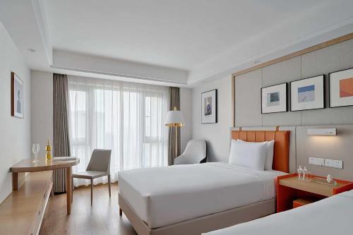 Postel nebo postele na pokoji v ubytování OneJasper Horizon Hotel
