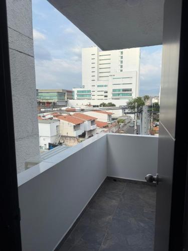 a balcony with a view of a city with buildings at Hermosa habitación a una cuadra del Ventura Plaza 4 in Cúcuta
