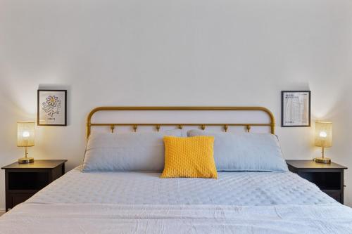 a bedroom with a bed with a yellow pillow on it at Secluded 9BR Getaway, Pool, Hot Tub & Huge Deck in Chester