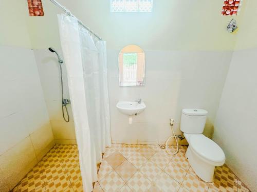 a bathroom with a toilet and a sink at Rinjani Garden Syariah by ecommerceloka in Sembalun Lawang