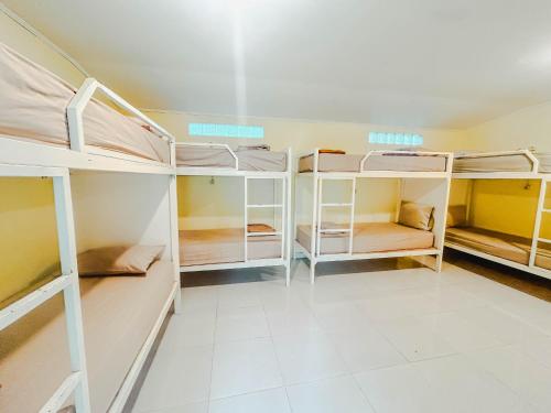 a room with several bunk beds in it at Rinjani Garden Syariah by ecommerceloka in Sembalun Lawang