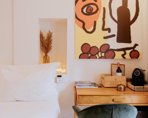 a bedroom with a bed and a desk with a chair at A Casa Brava in Santarém