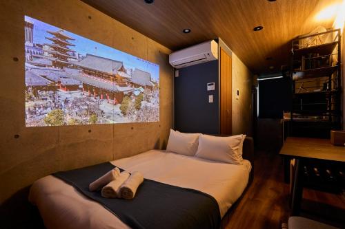 a bedroom with a bed with two towels on it at Life Town Oshiage - Compact Stay - Steps from Skytree in Tokyo