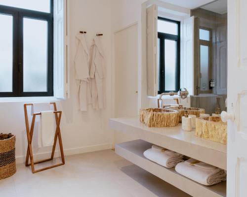 a bathroom with two sinks and a mirror at A Casa Brava in Santarém