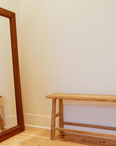 a wooden table in a room with a mirror at A Casa Brava in Santarém