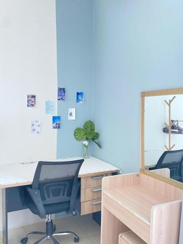 a blue room with a desk and a mirror at 8 pax KakaHomestay Tmn Petani Jaya in Sungai Petani