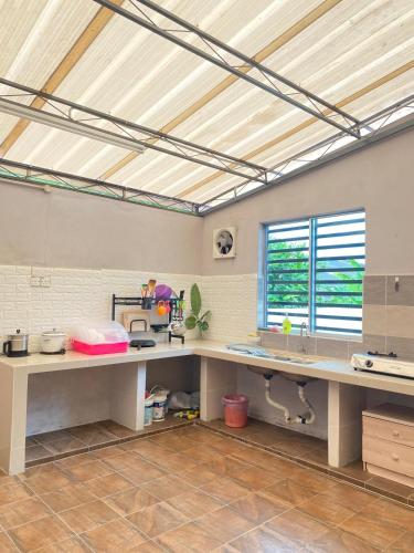 a kitchen with a large long table in a room at 8 pax KakaHomestay Tmn Petani Jaya in Sungai Petani