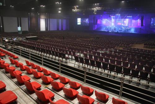 an empty auditorium with red chairs and a stage at Centara Grand At CentralWorld in Bangkok