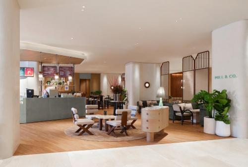 a lobby of a hotel with chairs and tables at Centara Grand At CentralWorld in Bangkok