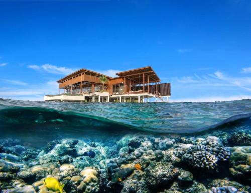 a house over the ocean over a coral reef at Park Hyatt Maldives Hadahaa in Gaafu Alifu Atoll