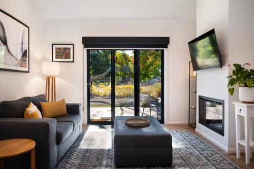 a living room with a couch and a table at Cosy Edge- charming studio on edge of town in Daylesford