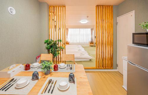 a room with a dining table and a kitchen at Mori hotel Akihabara 1 in Tokyo