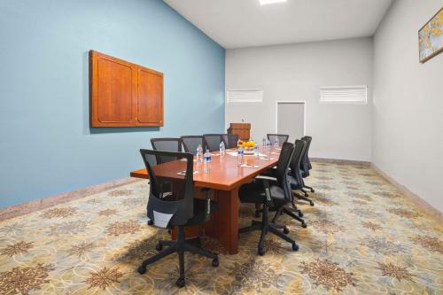 a conference room with a wooden table and black chairs at Richland Riverfront Hotel, an Ascend Collection Hotel in Richland