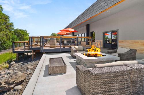 a patio with furniture and a fire pit and a deck at Richland Riverfront Hotel, an Ascend Collection Hotel in Richland
