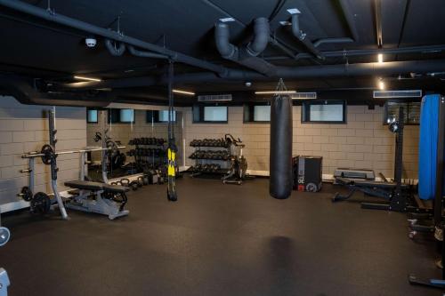 a gym with a punching bag and weights at The Florian Amsterdam Schiphol Airport, WorldHotels Crafted in Hoofddorp