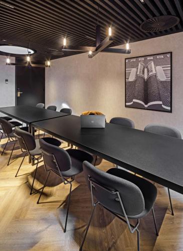 a conference room with a long table and chairs at The Florian Amsterdam Schiphol Airport, WorldHotels Crafted in Hoofddorp