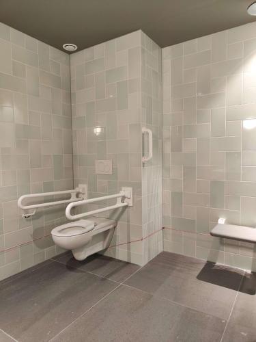 a bathroom with a toilet and a sink at The Florian Amsterdam Schiphol Airport, WorldHotels Crafted in Hoofddorp