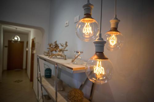 a room with several lights hanging from a wall at L'Approdo in San Leone