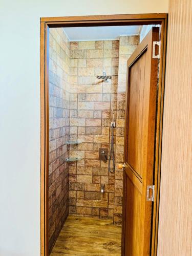 a bathroom with a shower with a glass door at Dylan's Penthouse in San Fernando