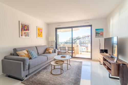 un salon avec un canapé et une télévision dans l'établissement 1 Bedroom Renovated Near Monaco, à Beausoleil