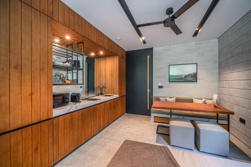 a kitchen with a wooden counter and a table at Body Factory Lifestyle Residence in Canggu