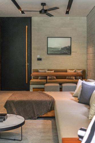a room with several beds and a ceiling fan at Body Factory Lifestyle Residence in Canggu