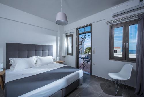 a bedroom with a bed and a view of the ocean at Casa Bianca Adults Only "by Checkin" in Hersonissos