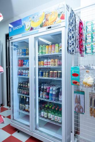 a refrigerator filled with lots of drinks in a store at Palace Suite Residence in Phnom Penh