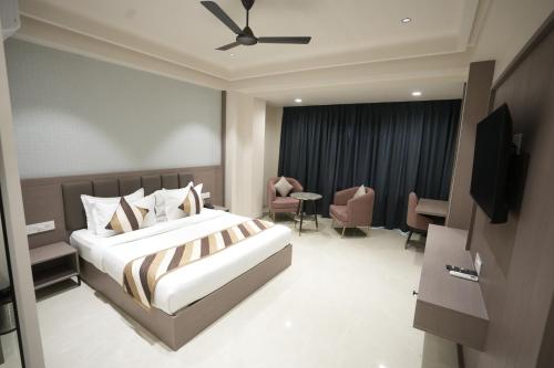 a hotel room with a bed and a television at Hotel shree ji inn in Kishangarh