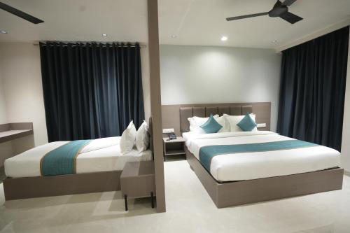 a hotel room with two beds and a window at Hotel shree ji inn in Kishangarh