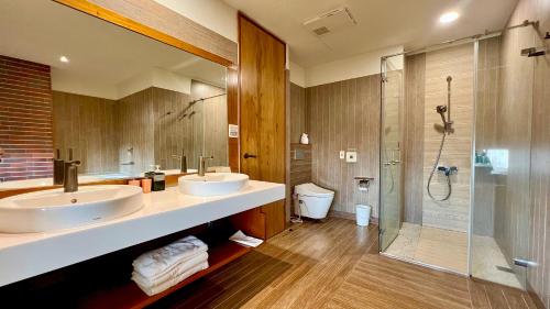 a bathroom with two sinks and a shower at 回長濱會館-原畫日風尚 Sinasera Resort in Changbin
