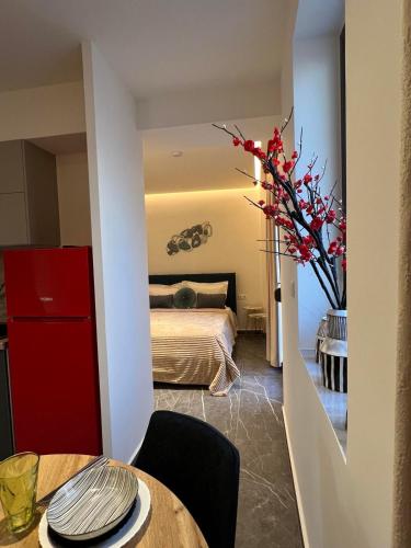 a bedroom with a bed and a table with a vase of flowers at Adas Aura - Boutique Apartments in Old Town Thessaloniki in Thessaloniki