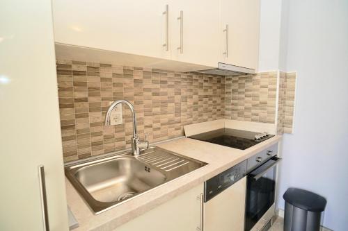 a kitchen with a sink and a counter top at La Perla Adriatica apartments Trogir-Seget in Seget Vranjica