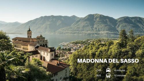 a view of a town with a lake and mountains at Locarno Center - Casa Incanto - Free Parking & Washer in Locarno