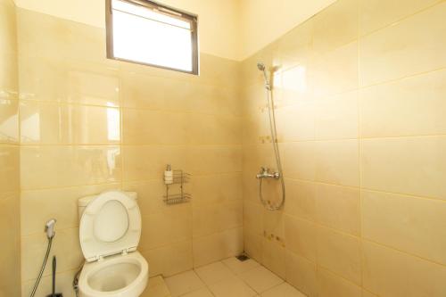 a bathroom with a toilet and a shower at Family Only Spacious Hill View Villa - De Reiz Zakir Syariah 5BR in Ciburial