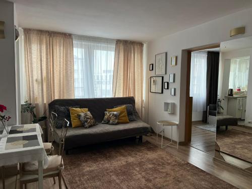 a living room with a couch and a table at Vicky - New Apartment Centrum Srodmiescie in Warsaw